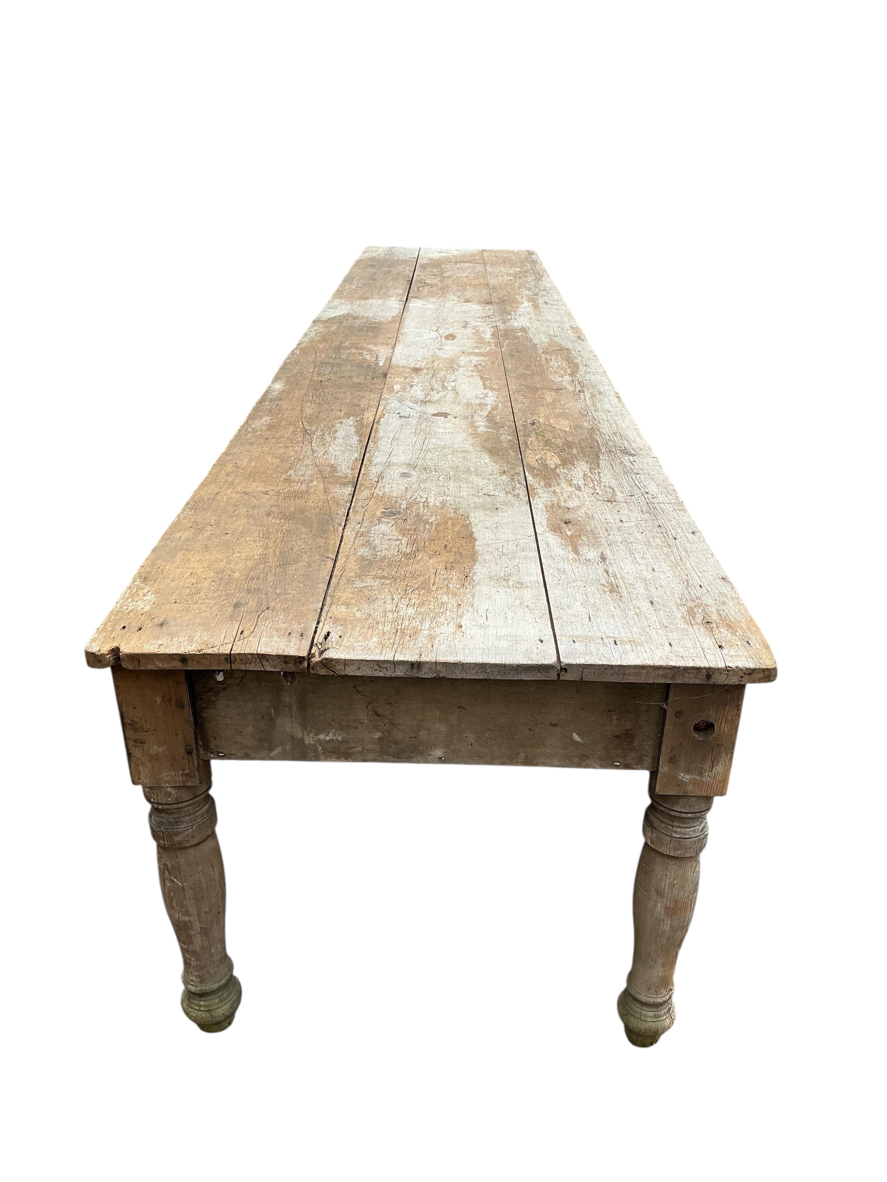 A long Victorian pine laundry table, length 600cm, width 104cm, height 86cm